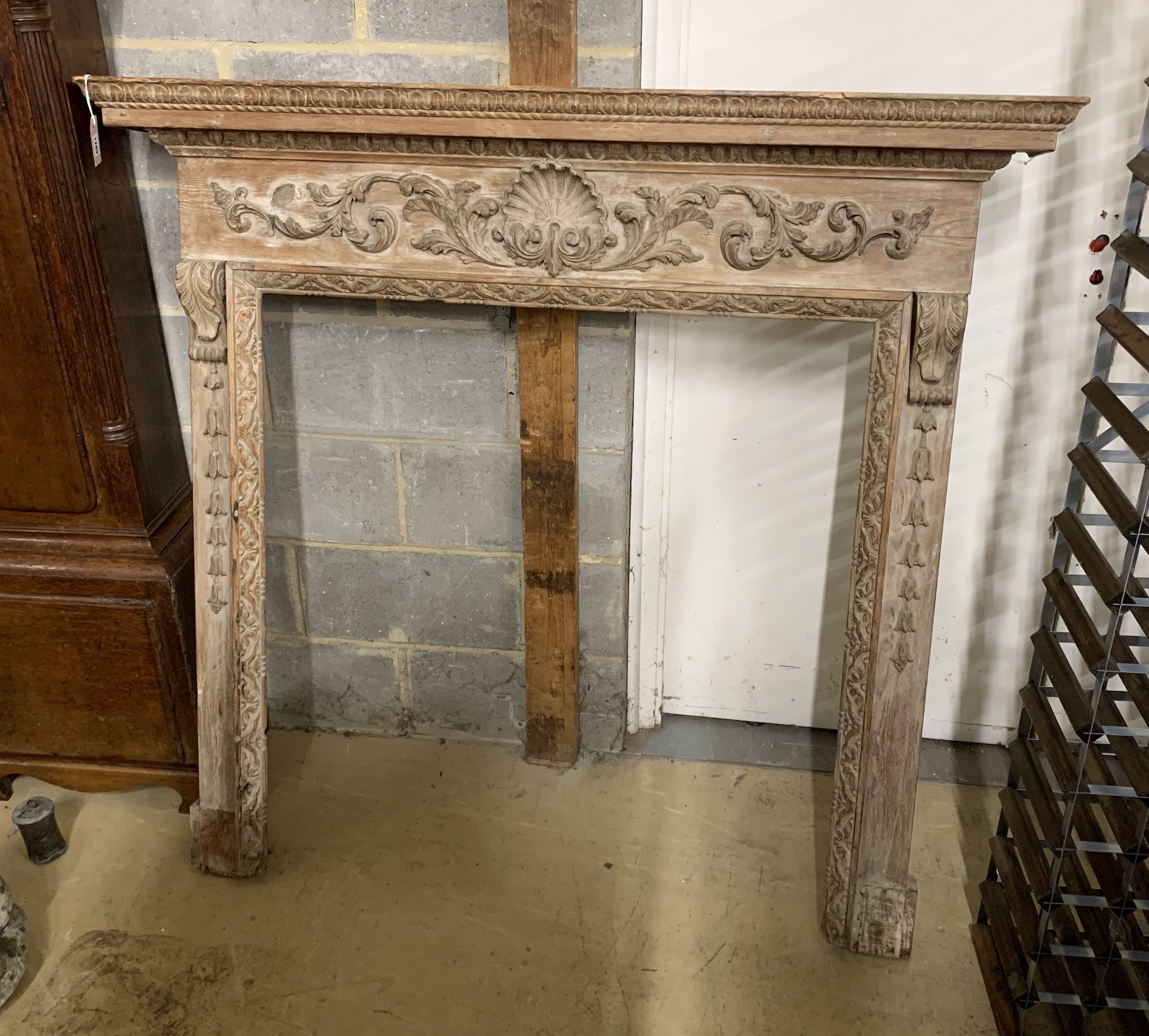 A Georgian carved pine fire surround, width 143cm, height 135cm (aperture width 96cm, height 105cm)